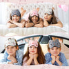 Three children smiling while wearing cute animal cartoon sleep masks in a bright bedroom setting.