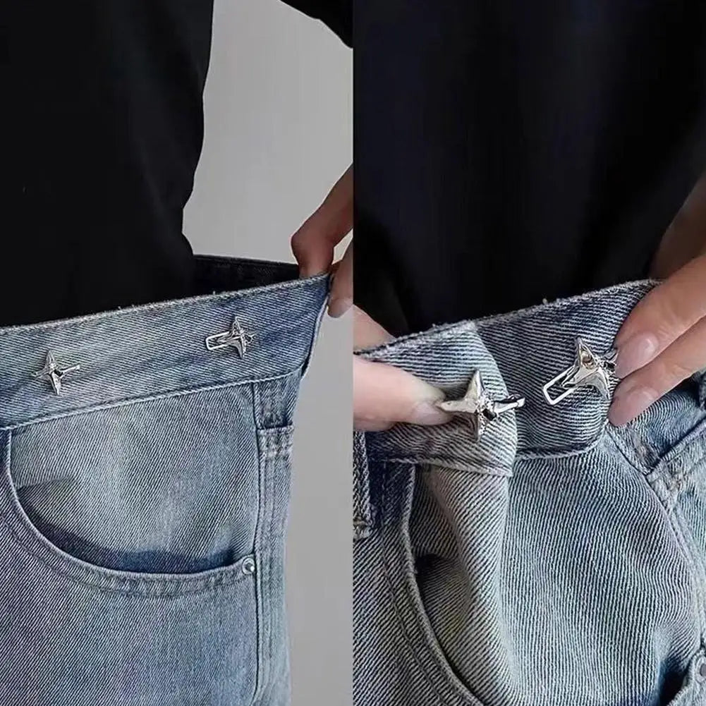 Close-up of a hand adjusting an adjustable waist tightening buckle on the pocket of denim jeans.