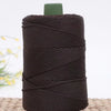 A dark brown crochet ice rope with a green cap, coiled and ready for DIY crafts.