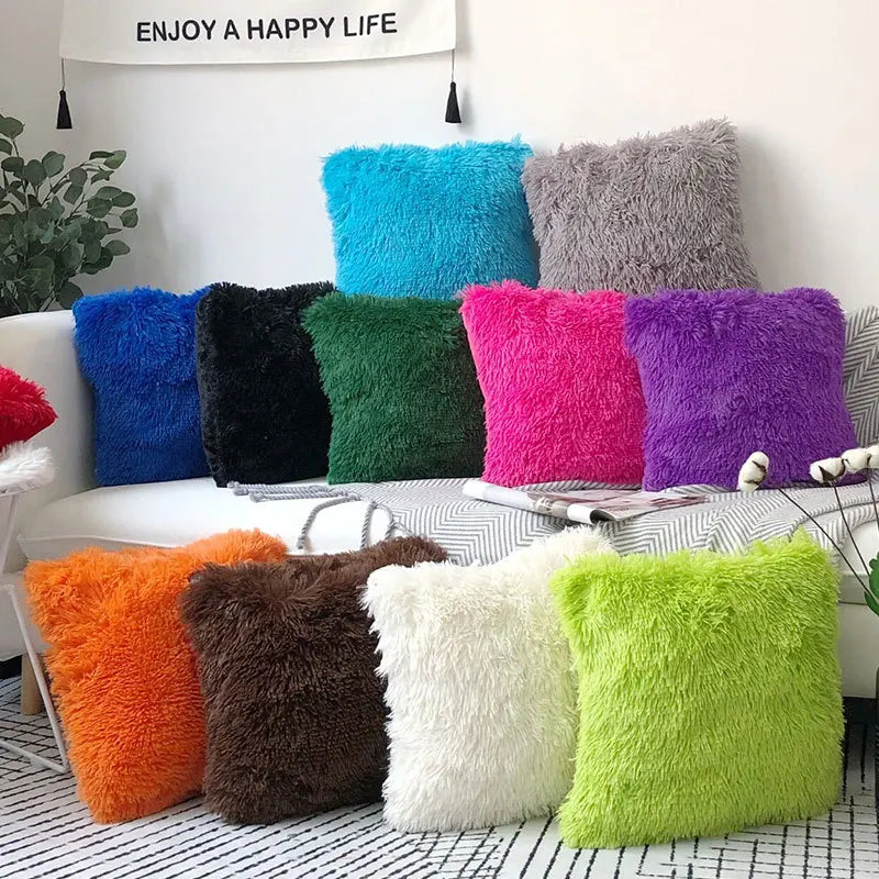A collection of colorful faux fur throw pillows in shades of blue, green, purple, pink, and orange displayed on a white sofa.