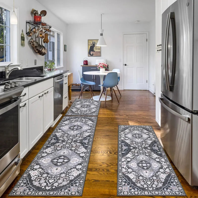 A set of patterned anti-slip floor rugs in gray and white placed on a wooden floor.