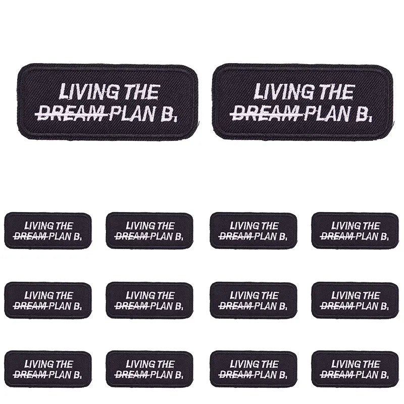 Set of black embroidered letter slogan applique patches with the text Living the Dream Plan B