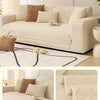 A beige plush winter sofa cushion cover displayed on a light-colored sofa with neutral pillows and a rug.