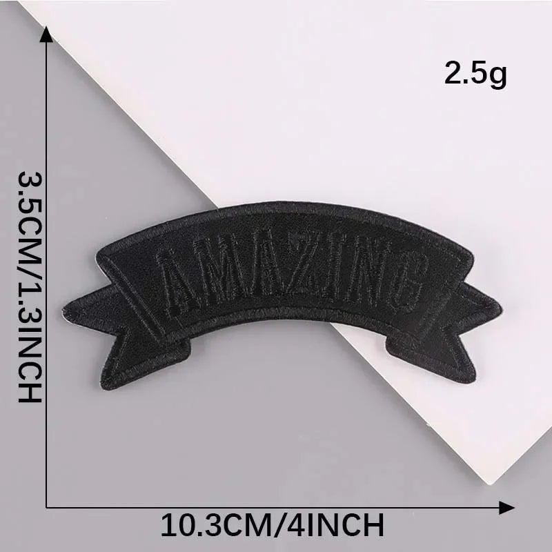 Black embroidered leather patch with the word AMAZING on it, measuring 10.3cm wide and 3.5cm high.