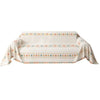 A beige accent sofa cover featuring a geometric patterned design with orange and teal accents.