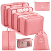A set of pink travel storage organizers including a zippered case and a fabric drawstring bag.