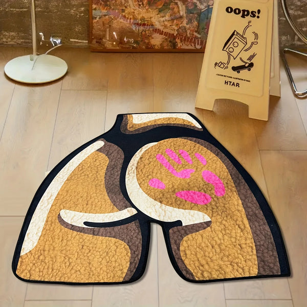 A rectangular area rug featuring a stylized, abstract design in shades of gold, brown, and pink on a dark background.