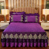 Purple bed skirt set with matching pillowcases and a purple quilted bedspread in a bedroom setting.