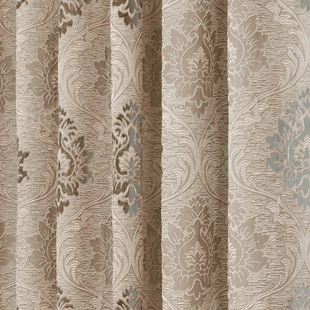 A close-up of a beige and gray European style sheer jacquard curtain panel with an ornate floral pattern.