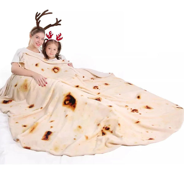 A young girl and woman pose with a light beige plush throw blanket featuring a funny pizza pattern.