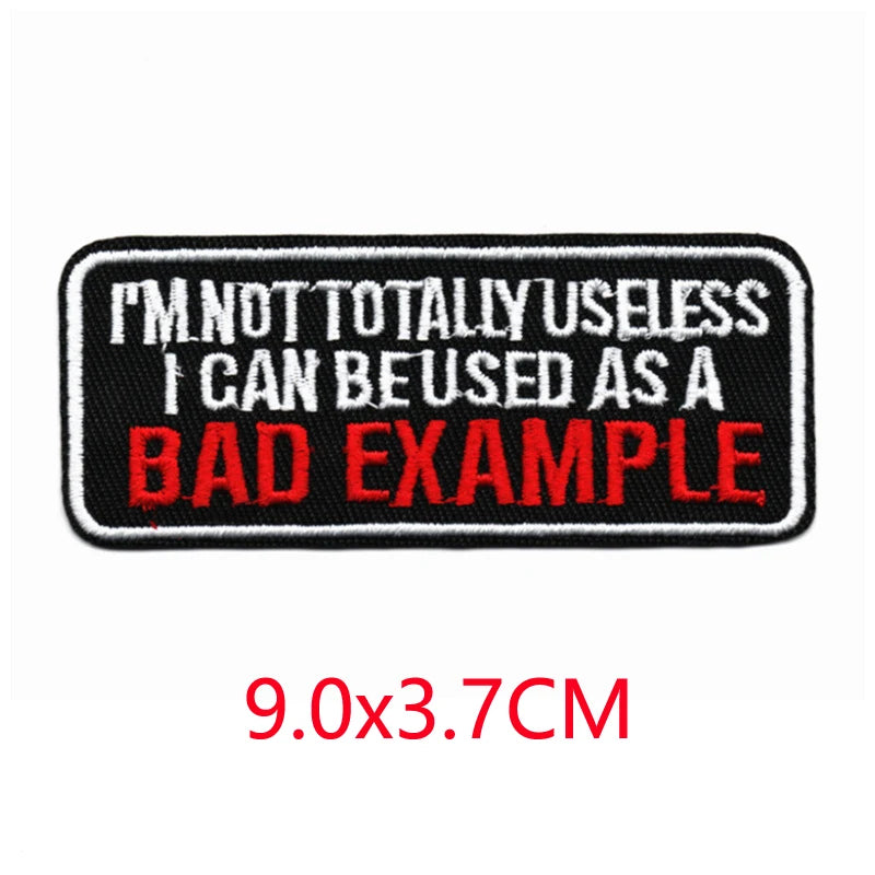 Black embroidered letter patch with red text that reads I'M NOT TOTALLY USELESS I CAN BE USED AS A BAD EXAMPLE