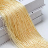A bundle of golden thread curtain tie-back material is displayed next to a white box.