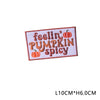 Iron-on patch with embroidered text FEELIN' PUMPKIN SPICY on a white fabric background