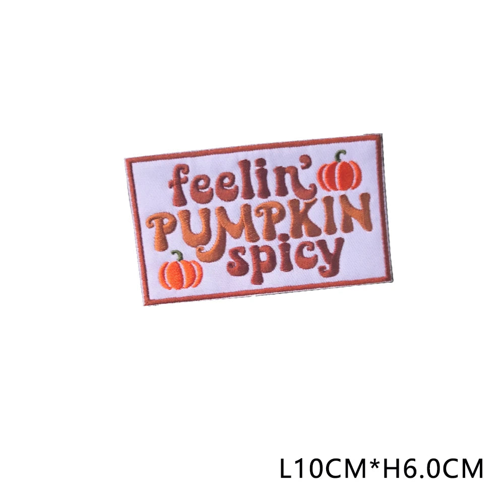 Iron-on patch with embroidered text FEELIN' PUMPKIN SPICY on a white fabric background