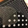 A clear acrylic quilting ruler with corner templates is shown on a black background.