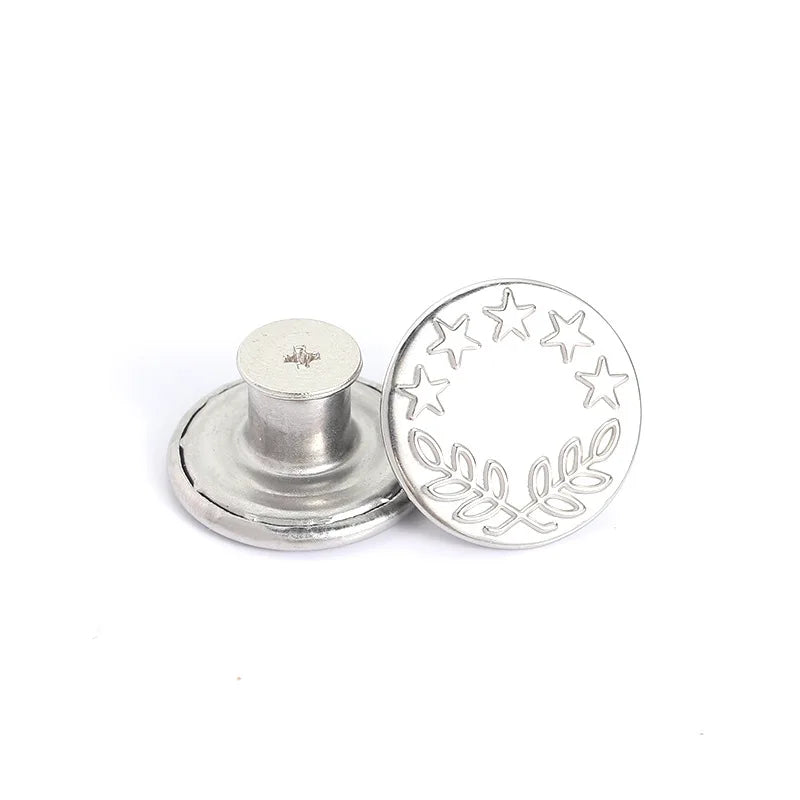 Silver metal button with a decorative leaf and star pattern for clothing