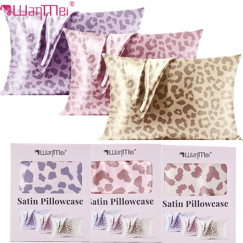 Three satin pillowcases in leopard print featuring various shades of pink and beige.