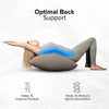 A person lying down using an inflatable leg elevation pillow to support the lower back and improve posture.