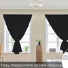 Blackout window curtains are installed in a window frame with sheer white curtains visible.