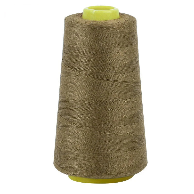 A roll of brown sewing thread with a yellow cap.