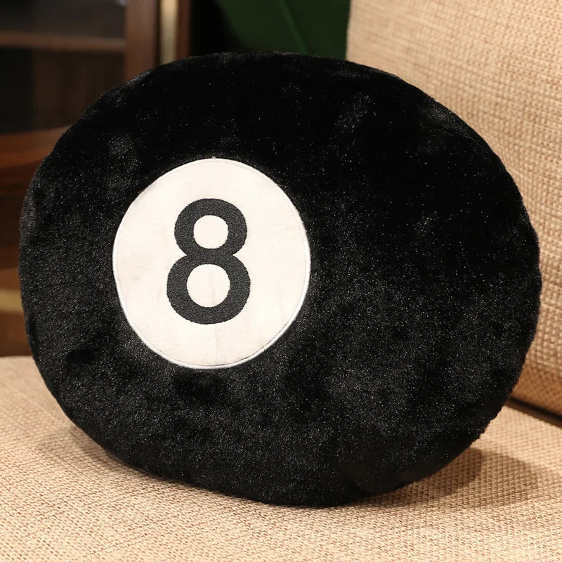 A black velvet plush pillow with a white number 8 embroidered on it.