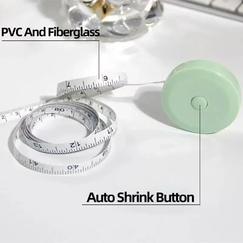 A light green retractable double-sided measurement tape with a shrink button is shown next to a ruler.