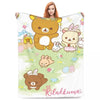 A plush throw blanket featuring various cute animal characters like bears and rabbits on a light green background.