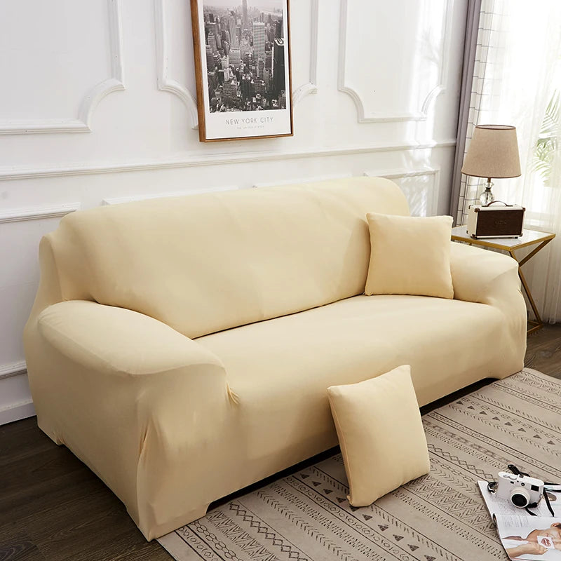 A light beige elegant faux silk sofa cover displayed on a modern sofa in a well-lit room.
