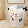 A white foldable unicorn storage basket filled with gray fabric, featuring pink unicorn illustrations.