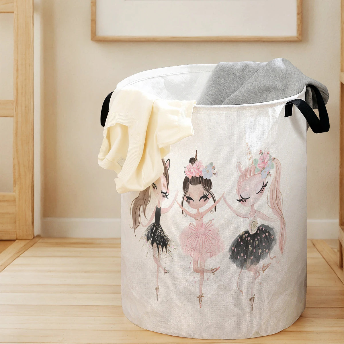 A white foldable unicorn storage basket filled with gray fabric, featuring pink unicorn illustrations.
