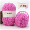 Two bright pink fluffy coral velvet yarn balls packaged for crafting
