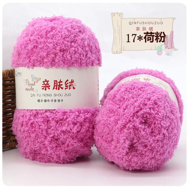 Two bright pink fluffy coral velvet yarn balls packaged for crafting