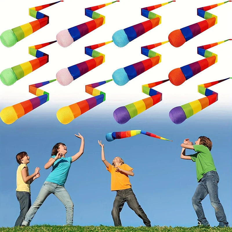 Rainbow comet ball with soft tail in various colors is shown being thrown against a blue sky.