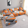 A modern sofa covered with stylish printed orange and gray geometric fabric.