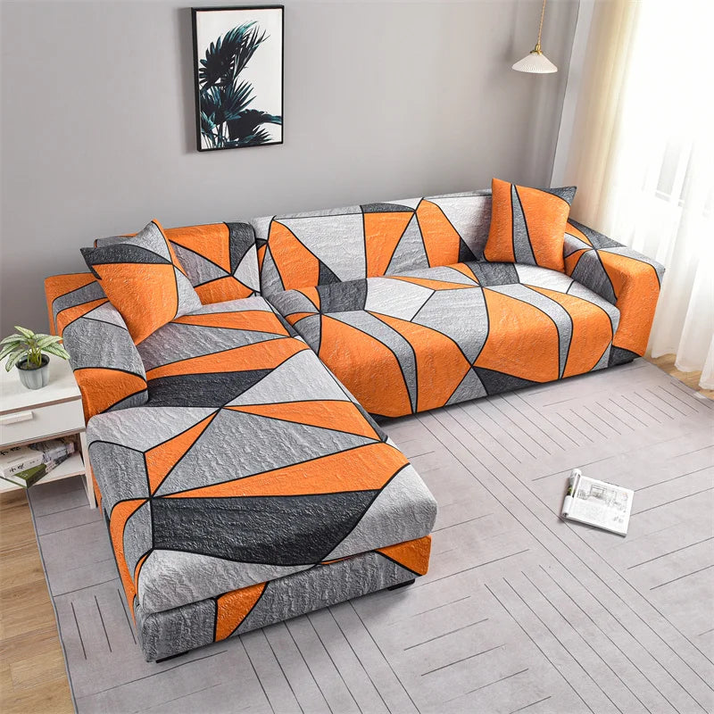 A modern sofa covered with stylish printed orange and gray geometric fabric.