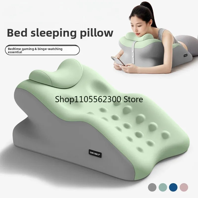 A green and gray ergonomic prostrate pillow is shown next to a woman using it for bedtime gaming and binge-watching.