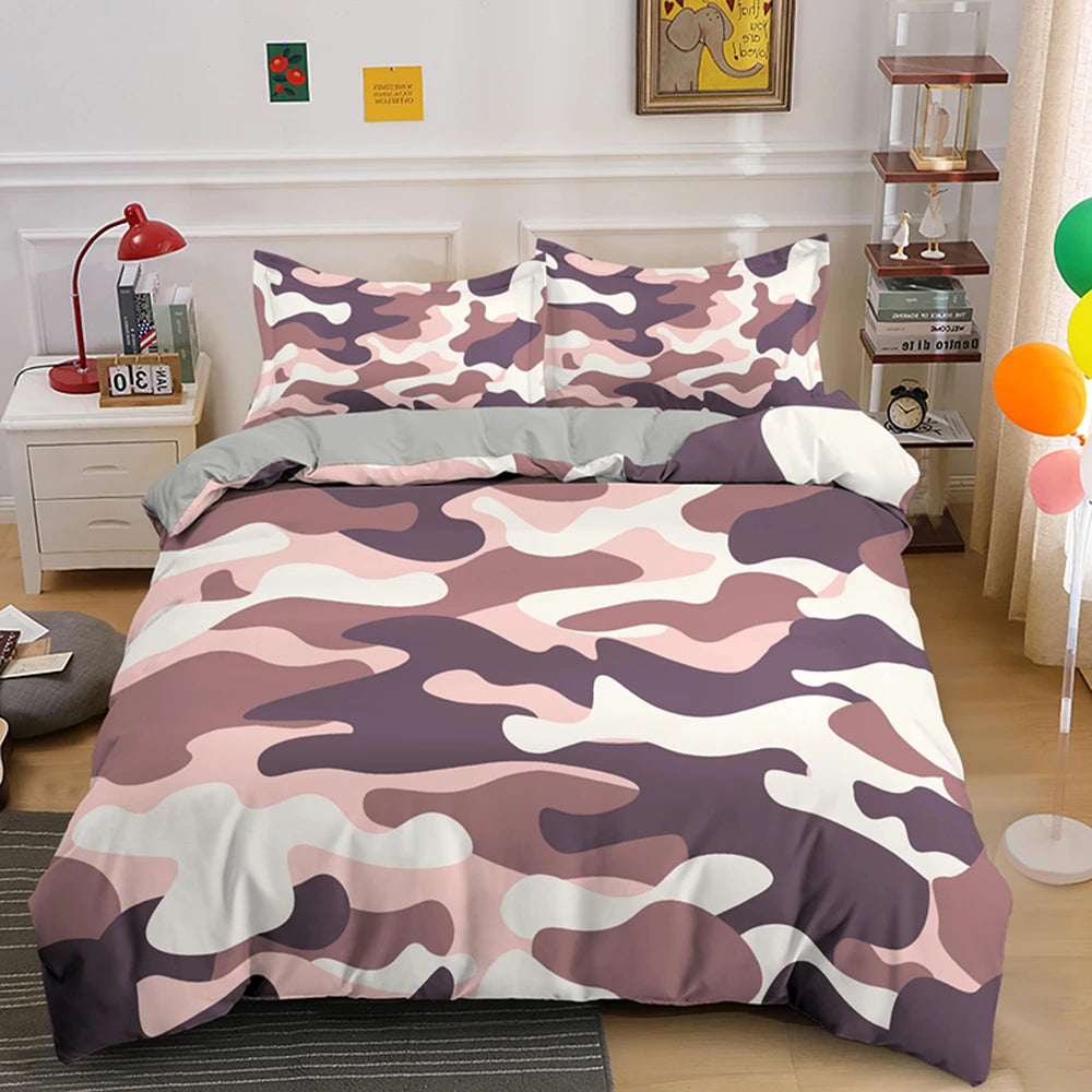 A duvet cover set featuring a pink, purple, and white camouflage pattern displayed on a bed.