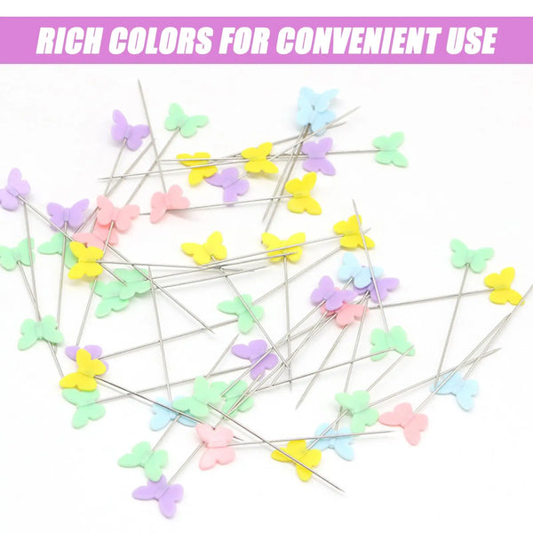 A bulk set of colored sewing pins in various pastel shades scattered on a white background.