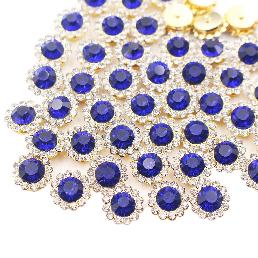A cluster of blue and clear crystal rhinestone buttons on a gold-toned setting.