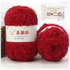 A pair of bright red fluffy yarn balls labeled as QINFUSHOUZUO, suitable for crafting.