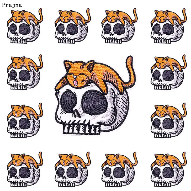 A collection of nine embroidered patches featuring skulls with orange cat heads