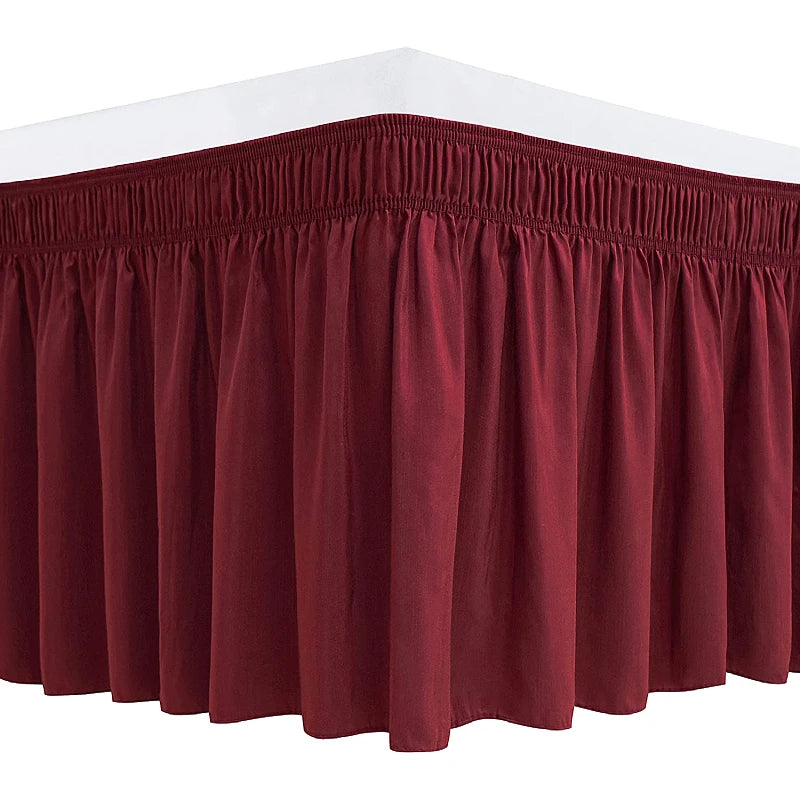 A maroon ruffle bed skirt with an adjustable elastic belt.