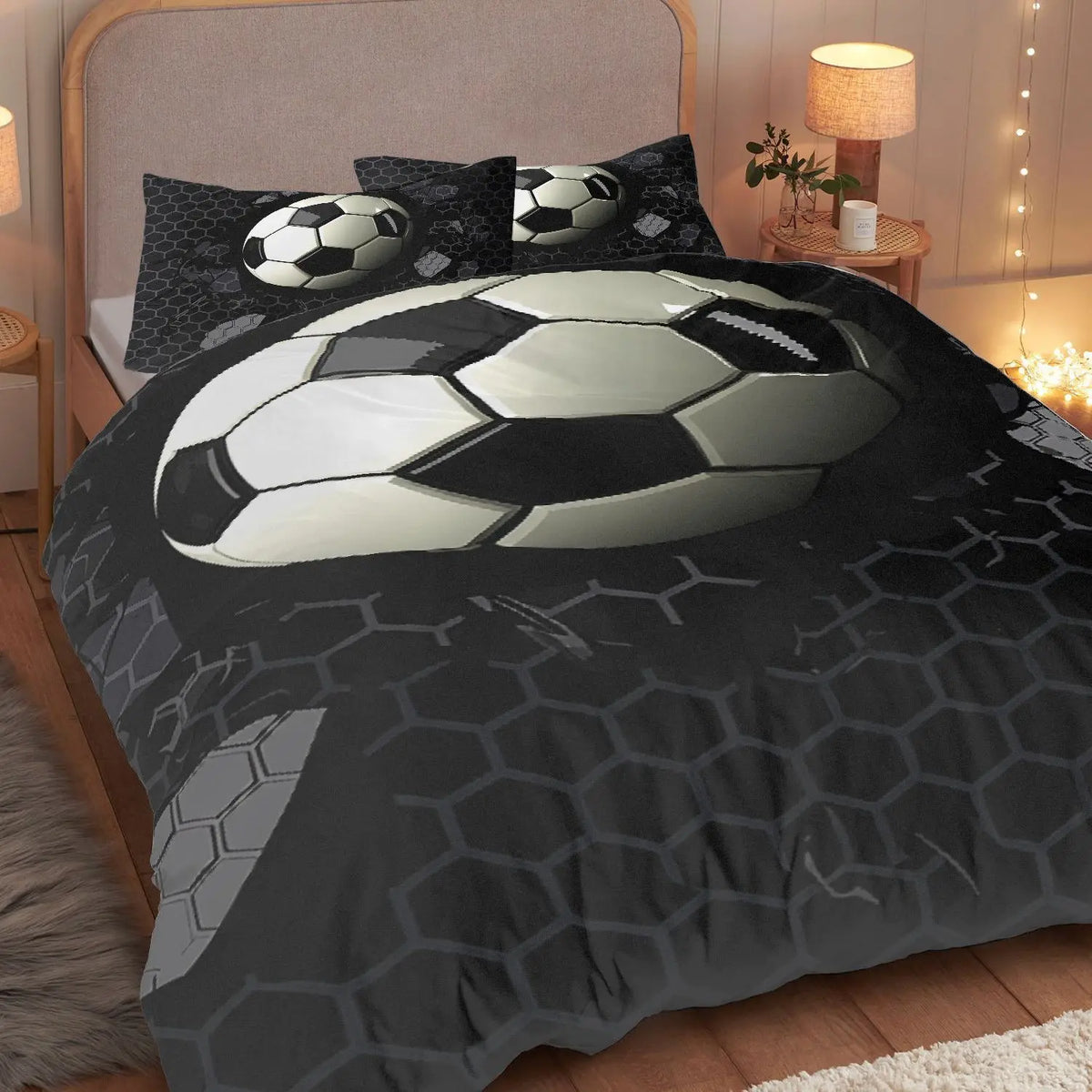 A soccer ball themed duvet cover set with three pillowcases featuring a large graphic of a soccer ball on a dark background.