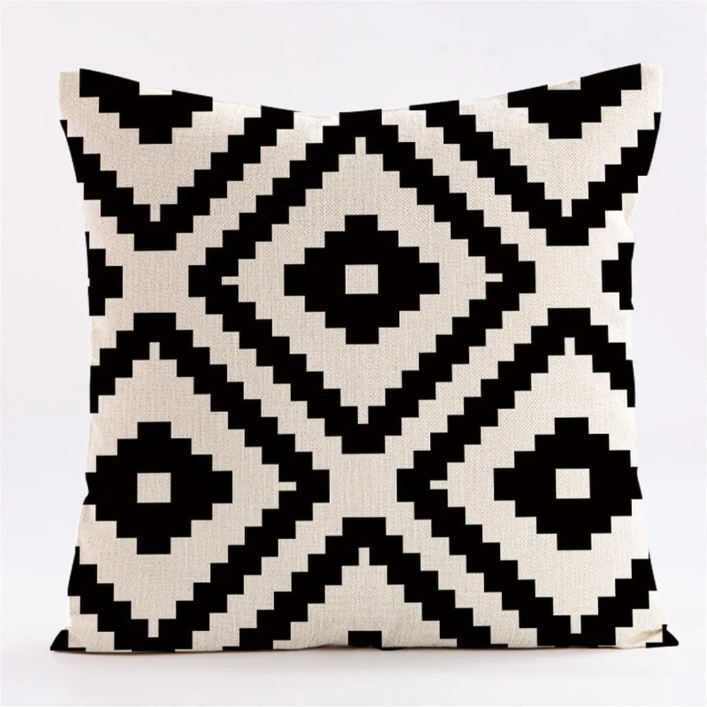 A throw pillow cover featuring a geometric black and white diamond pattern.