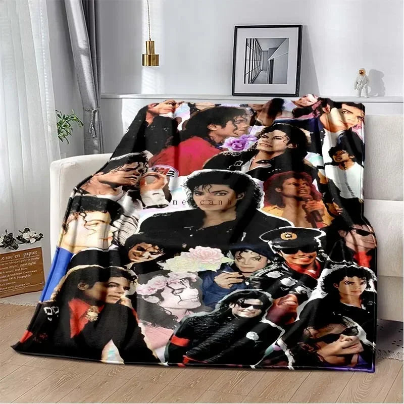 A printed flannel blanket featuring a collage of pop music artists' faces in black and white tones.