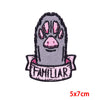 A dark gray embroidery patch depicting a stylized rose skull face with pink accents.