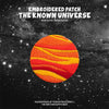 Embroidered patch featuring a striped orange and yellow planet against a dark, starry background.