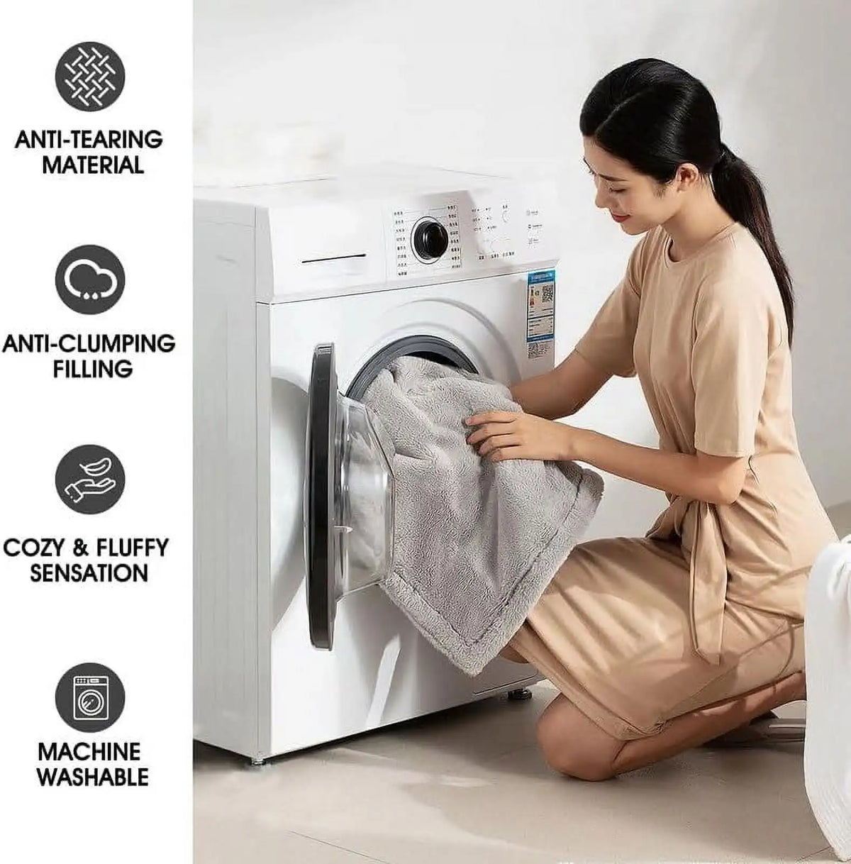 A woman is sitting next to a white washing machine, holding a gray throw blanket, demonstrating its features.