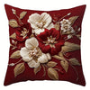 A deep red pillow cover featuring embroidered white and maroon floral designs on a dark background.
