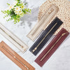 A collection of PU leather zipper frames in various colors and finishes laid on a white marble surface.